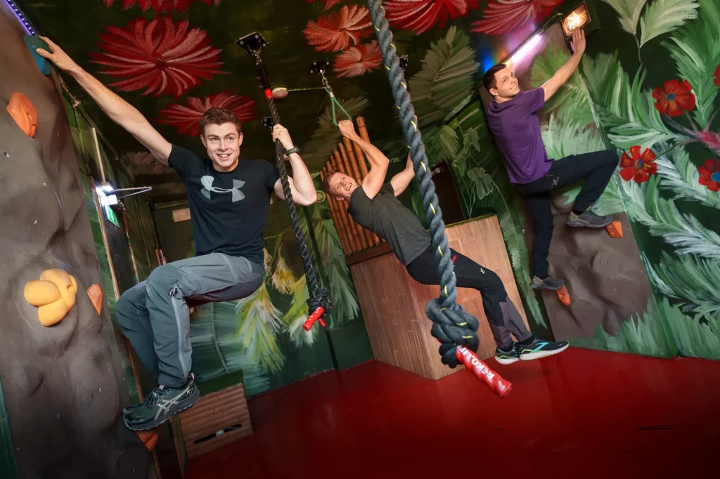 guys swinging from lianas