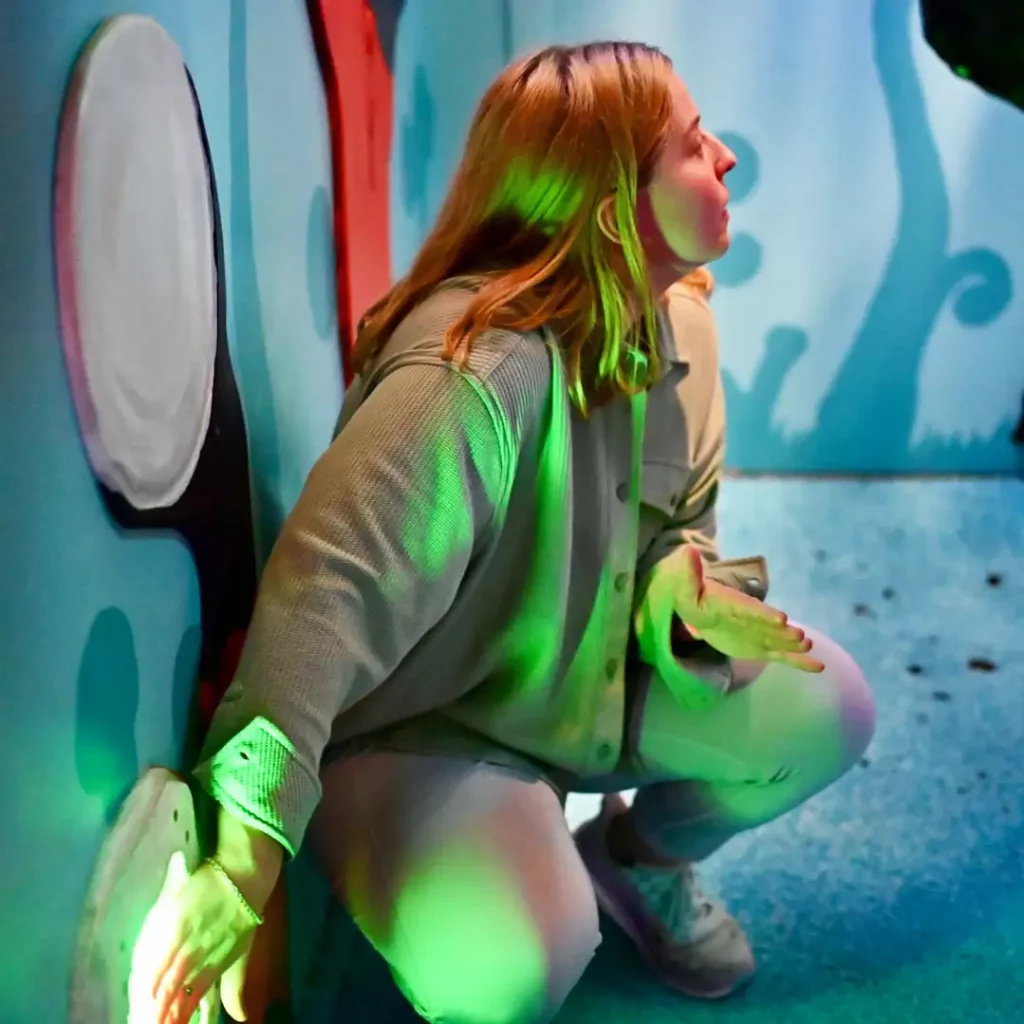 Blonde woman in blue room pushing a button