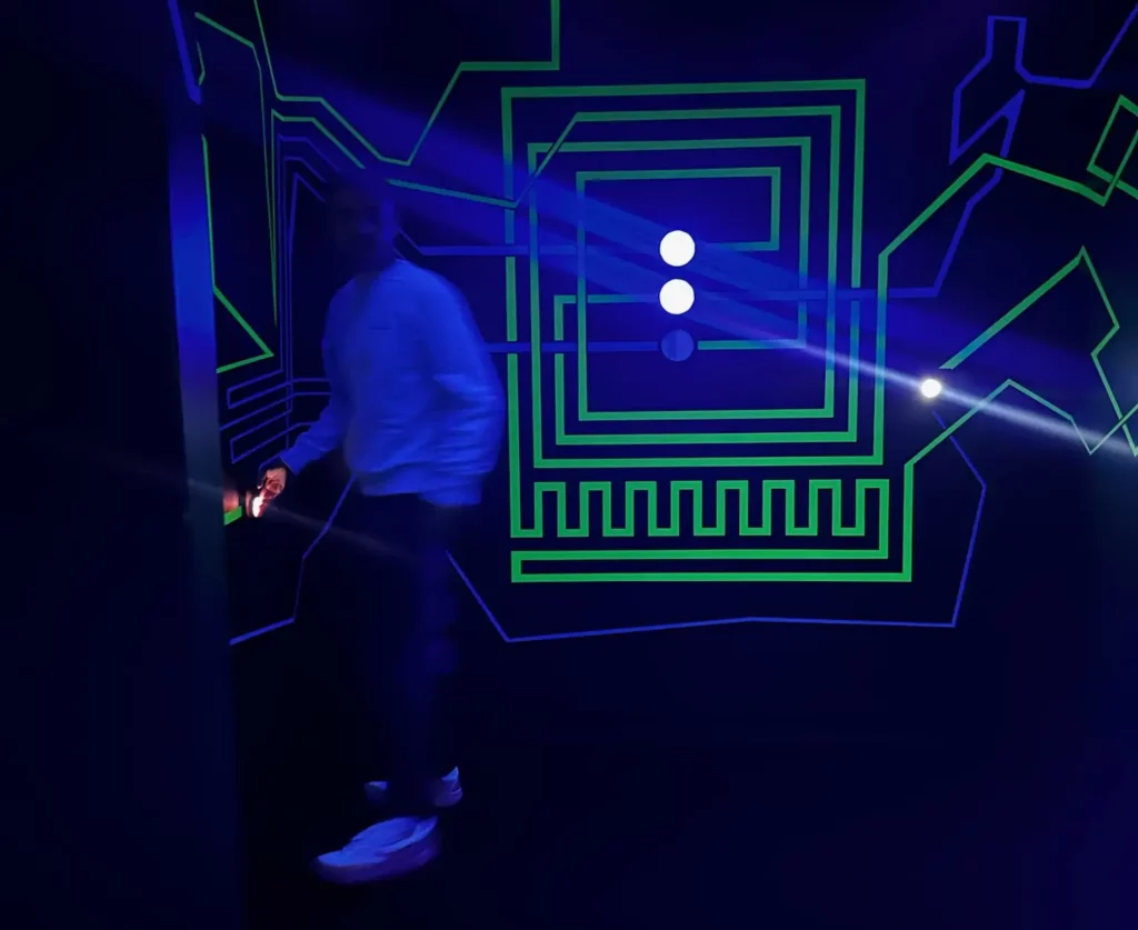 Guy in blue room with green lines