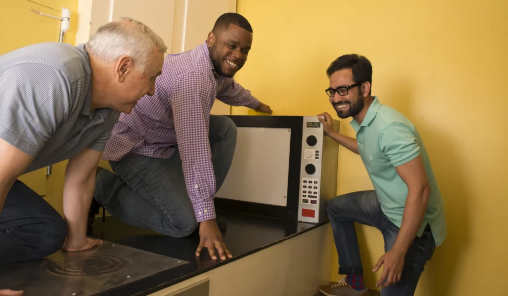 Three guys in an oversized kitchen