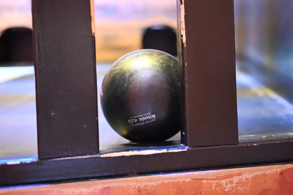 Black ball behind wood panels