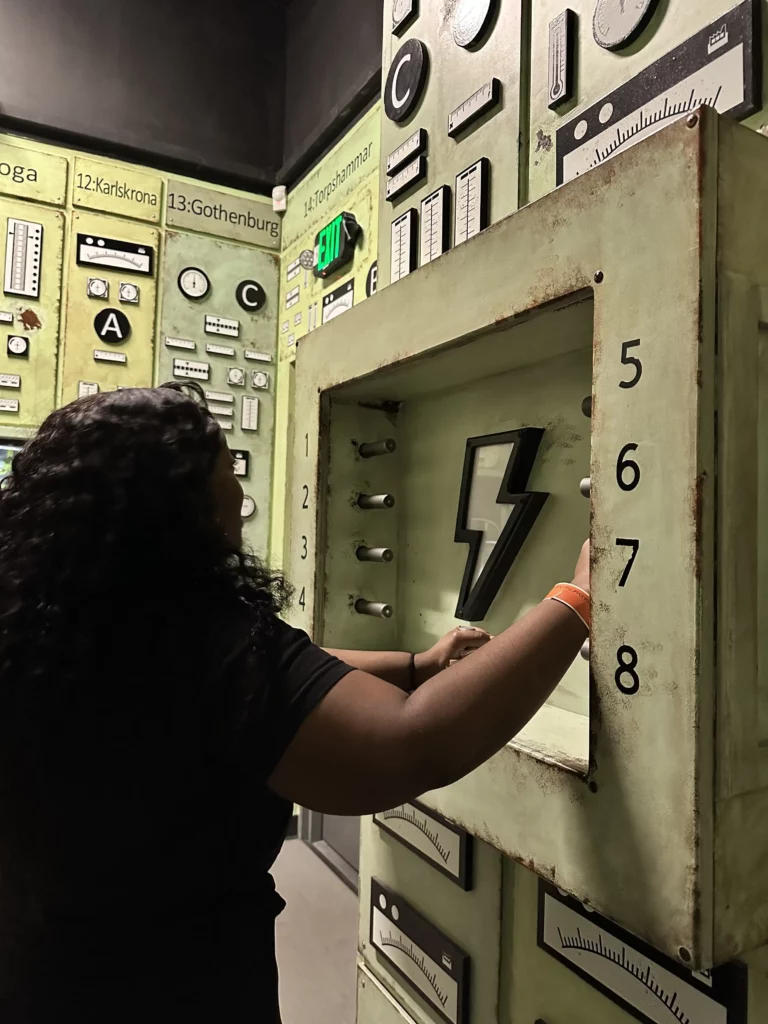 Woman holding metal bars near a lightening bolt