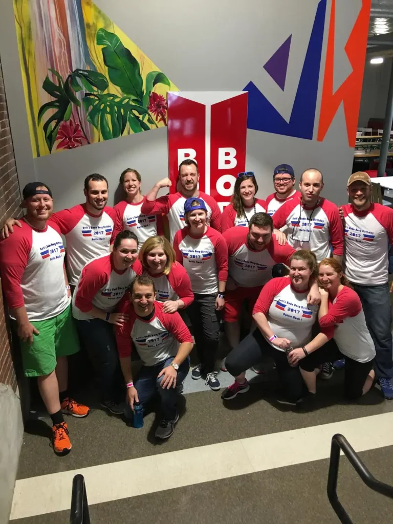 A group of adults in matching red shirts