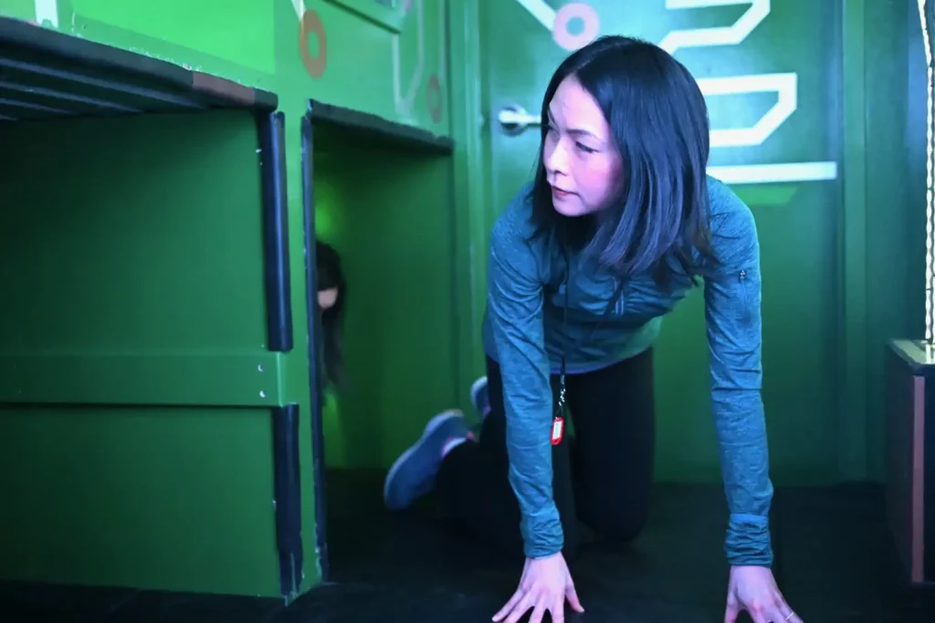 Woman crawling through a tunnel