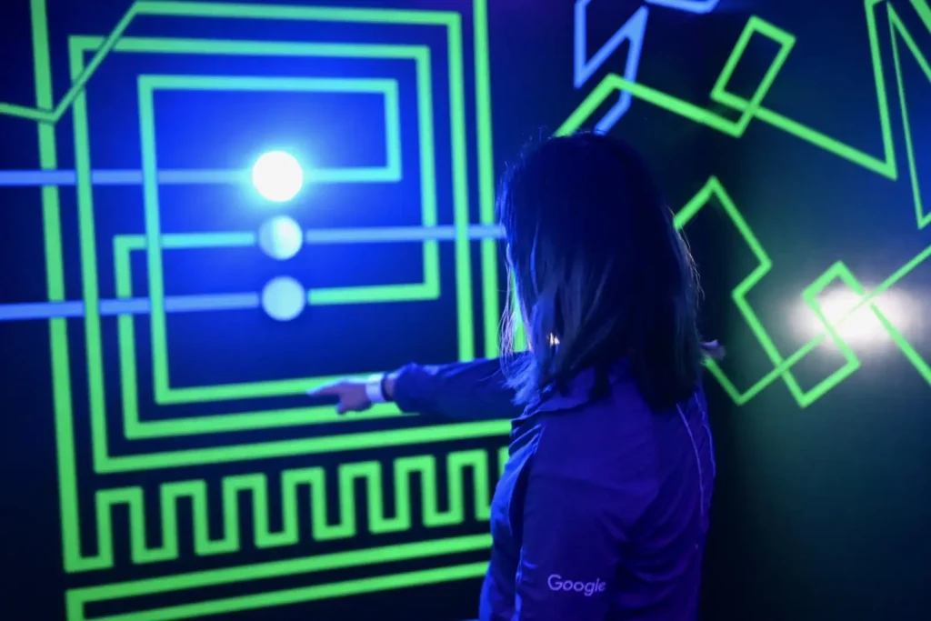 Back of a person looking at glowing black lit lines on wall