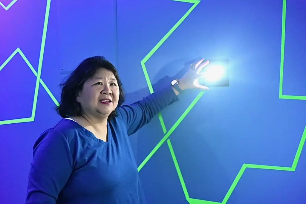Woman touching button on wall